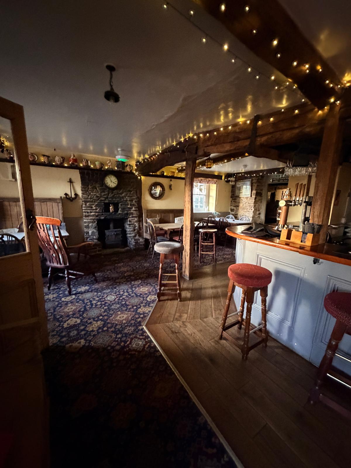 The country bar with stone fireplace, wood burner and beams